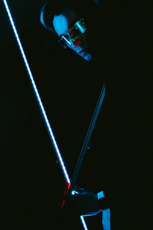 Futuristic scientist Captain Giroxx holding a glowing Beyblade with neon blue and gold highlights