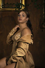Vibrant hair color transformation showcased under soft cinematic lighting with elegant gold accents.