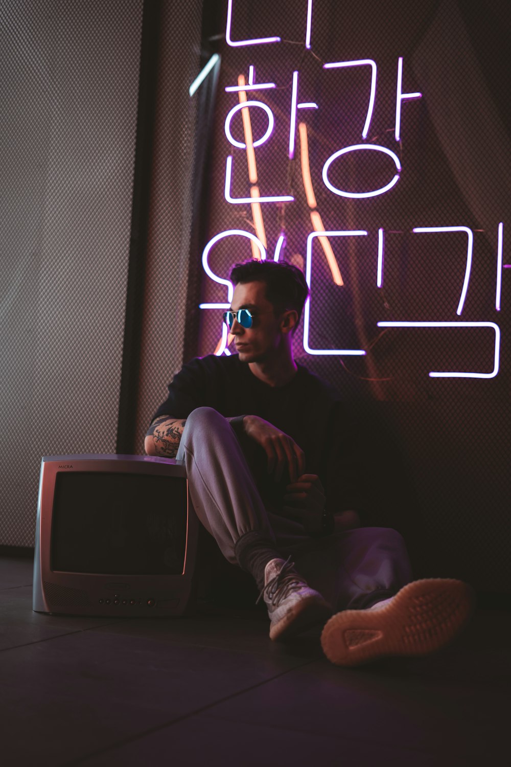 man in black jacket sitting on chair