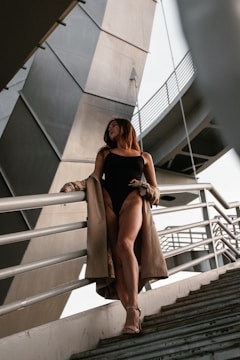 Glamorous swimsuit model walking confidently on an outdoor urban street