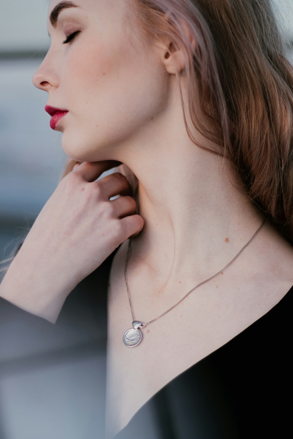 woman in black shirt wearing silver necklace