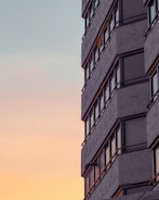 Modern luxury residential building exterior at sunset.