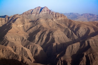 brown rocky mountain under blue sky during daytime
