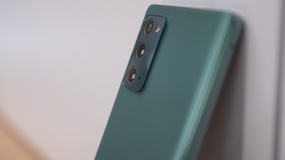 A sleek modern smartphone with a green accent background