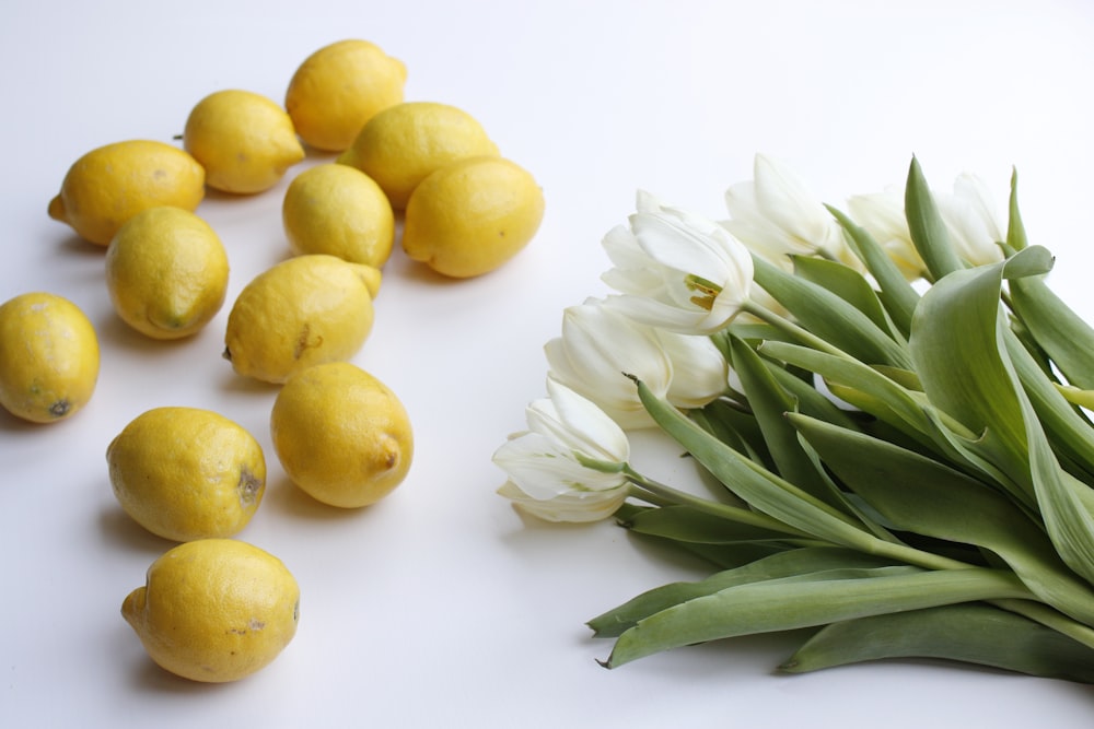 yellow lemon fruits on white surface