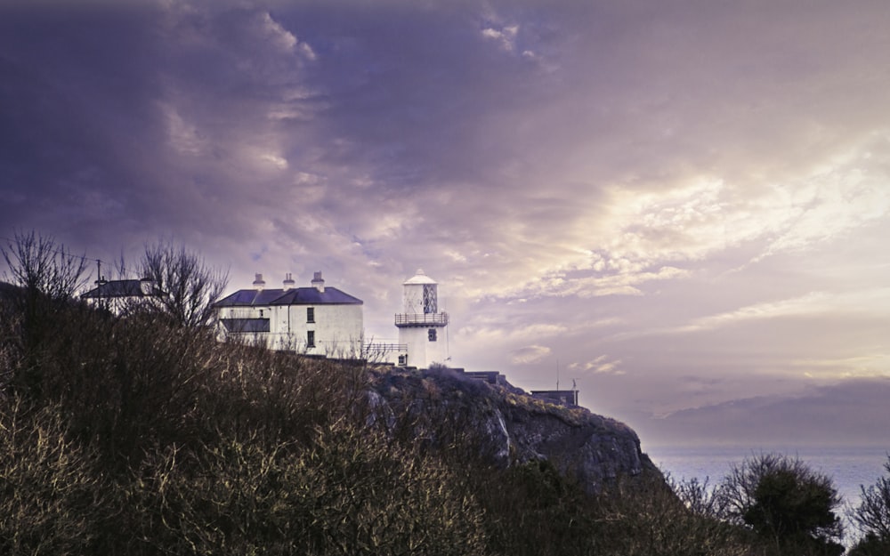 white concrete building on top of hill under cloudy sky during daytime