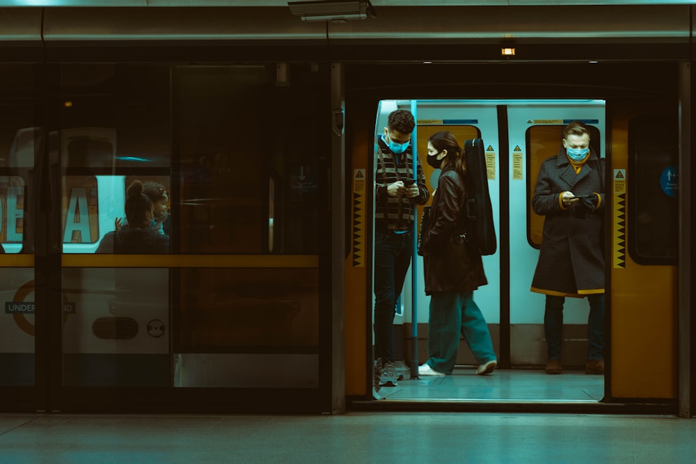 man in black coat standing in front of glass door