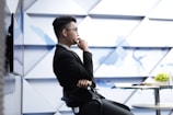 man in black long sleeve shirt sitting on black chair
