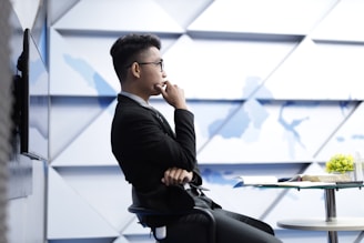 man in black long sleeve shirt sitting on black chair