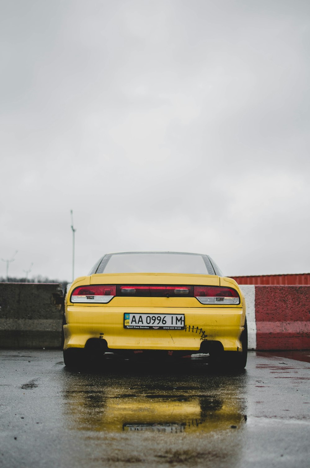 yellow car on gray asphalt road during daytime