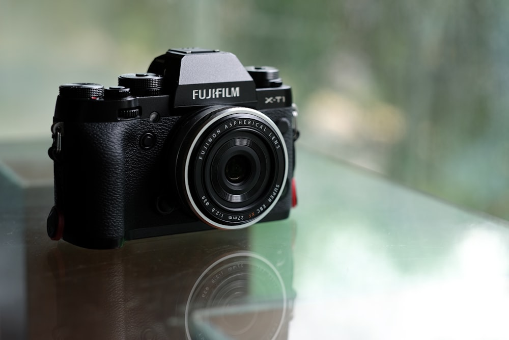 black nikon dslr camera on brown wooden table