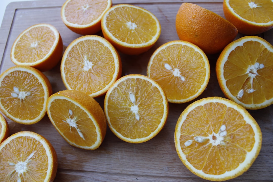 sliced orange fruits on brown wooden table