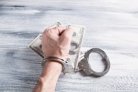 person holding silver ring on 100 us dollar bill