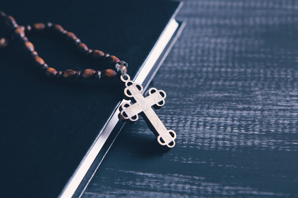 silver and brown crucifix pendant necklace