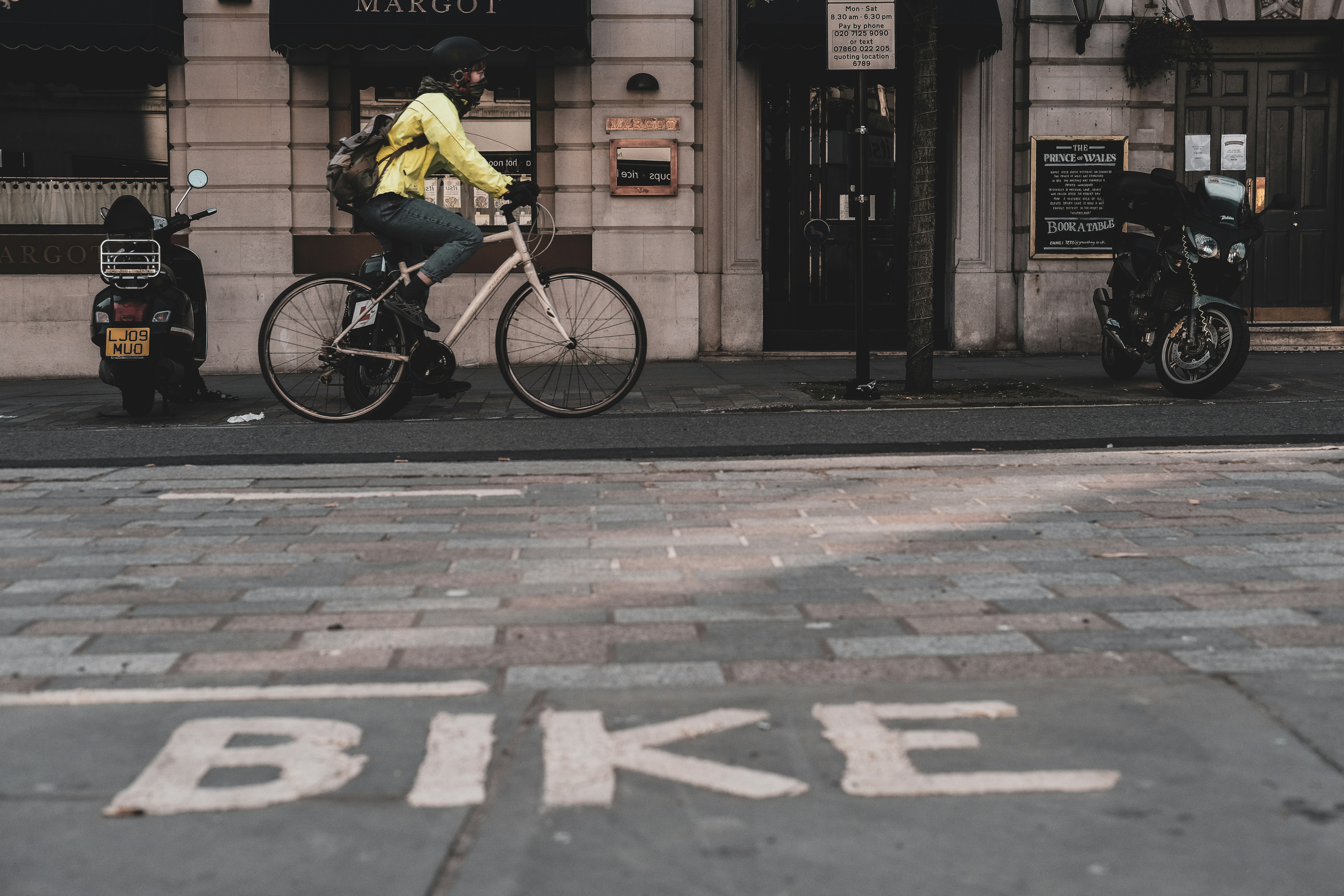 man in yellow shirt riding bicycle on sidewalk during daytime, 