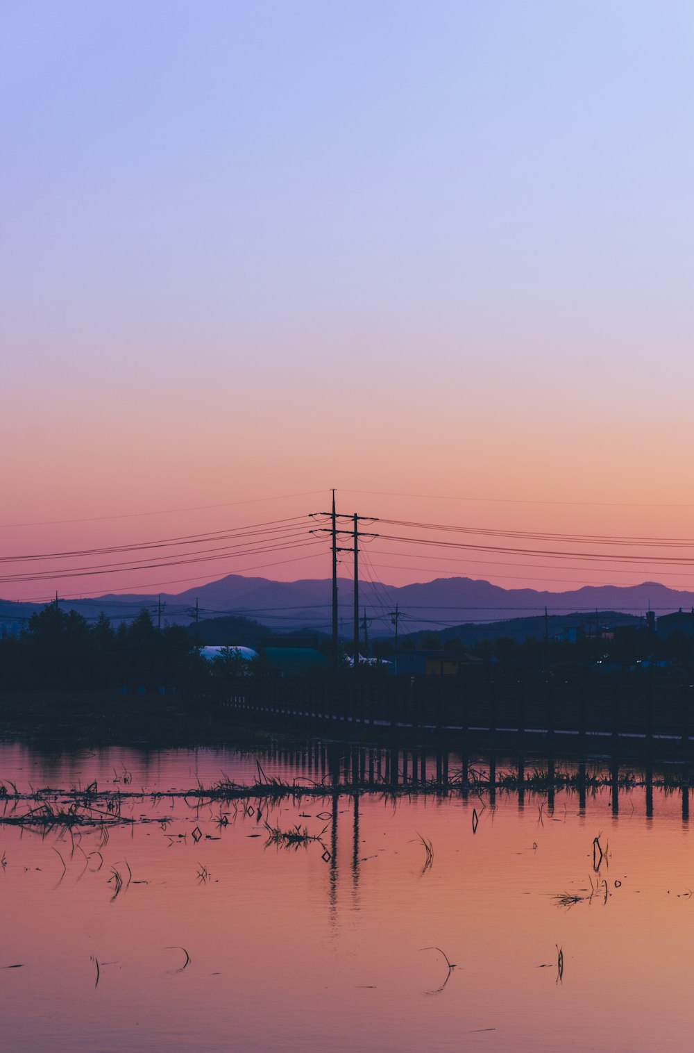 silhouette of mountain and trees during sunset