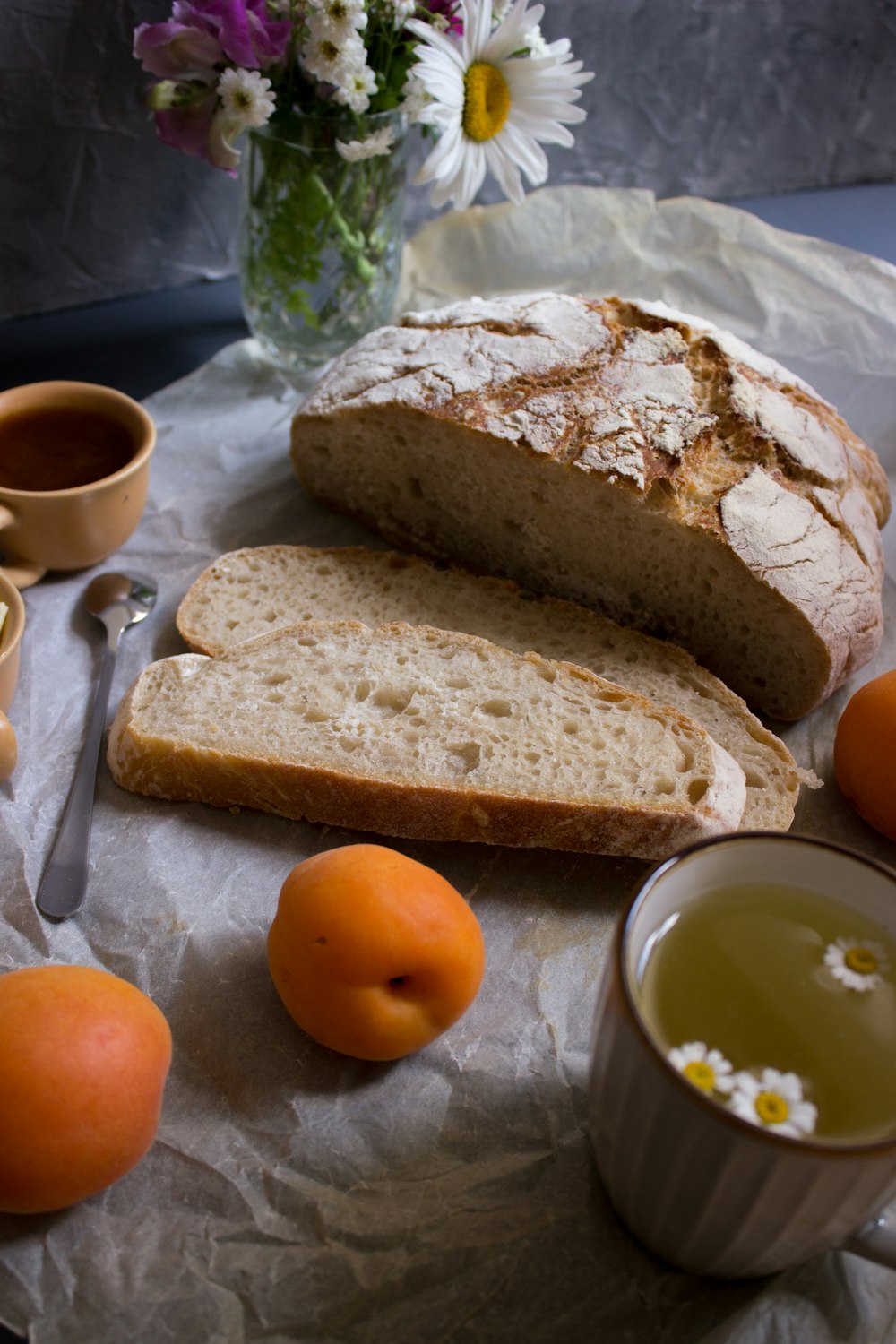 bread on white ceramic plate beside orange fruit