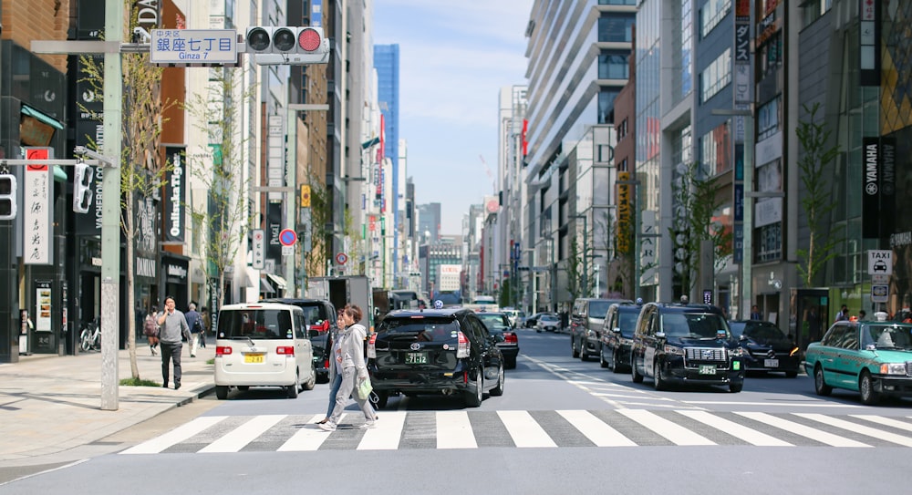 people crossing on pedestrian lane during daytime