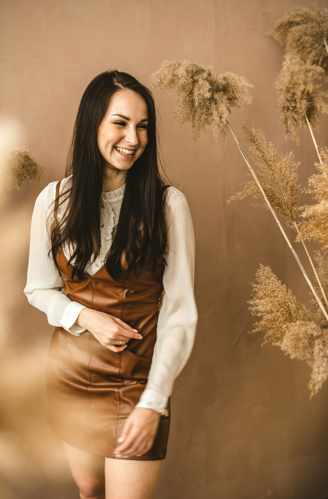 woman in white long sleeve shirt smiling