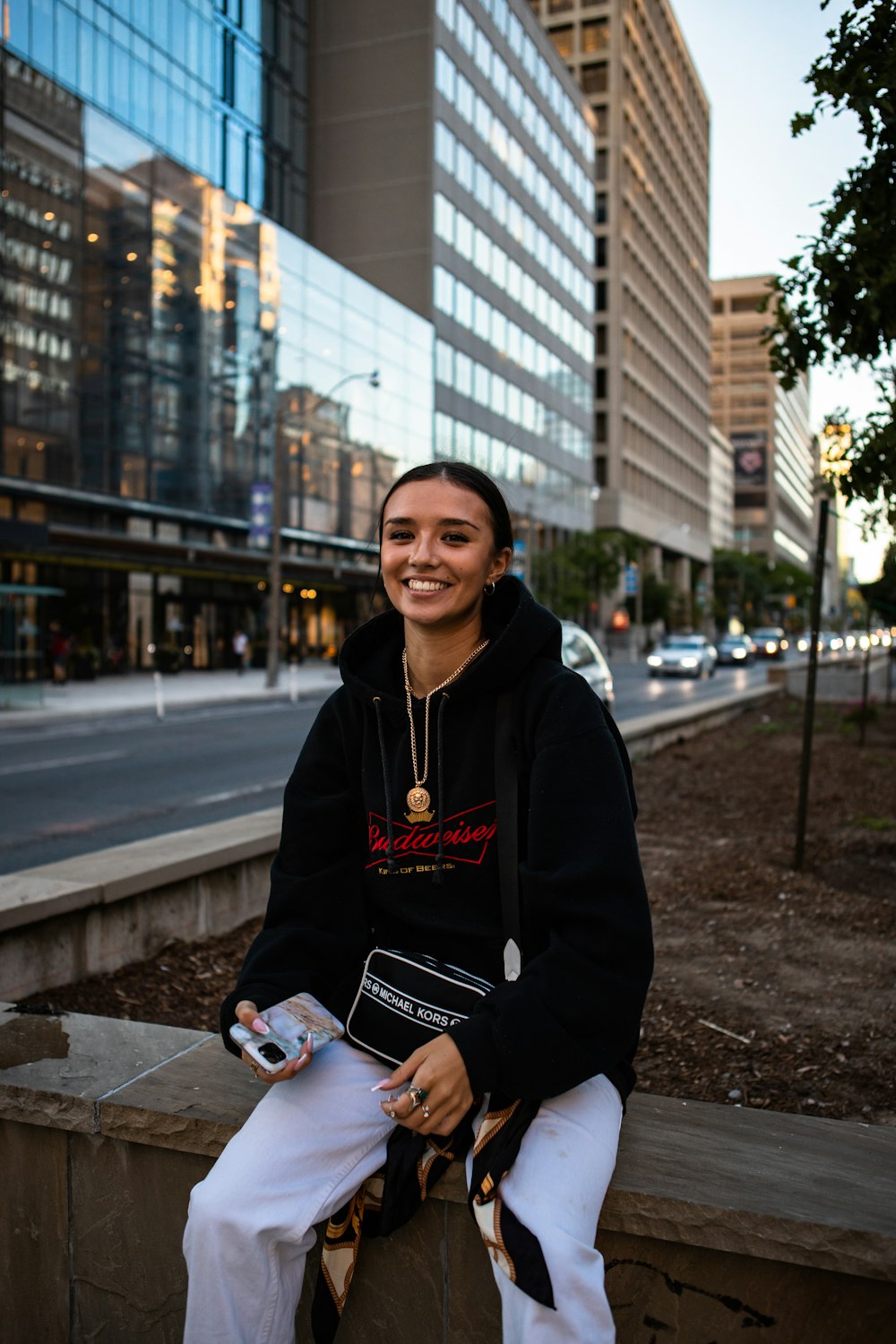 woman in black jacket holding white smartphone