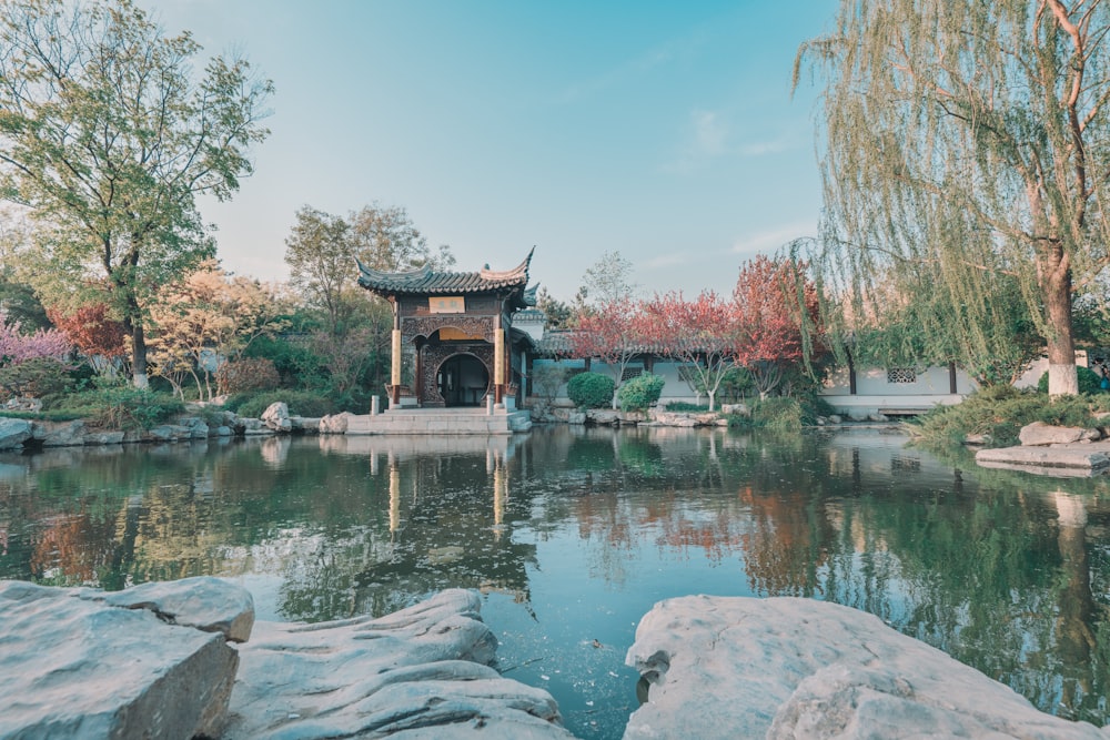 brown wooden gazebo on body of water during daytime