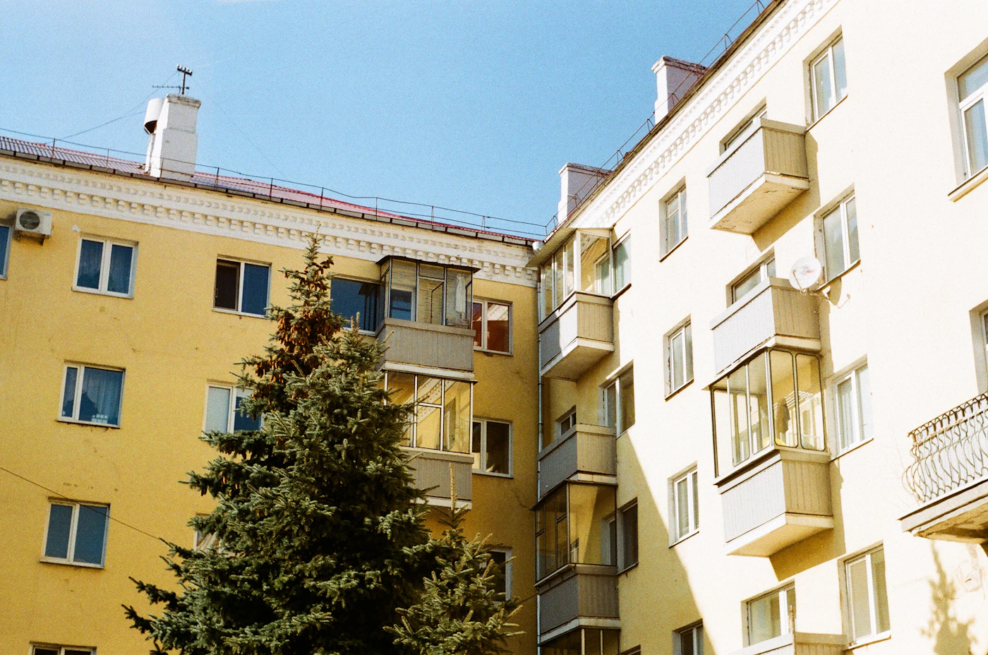 Yellow and white apartment buildings with balconies