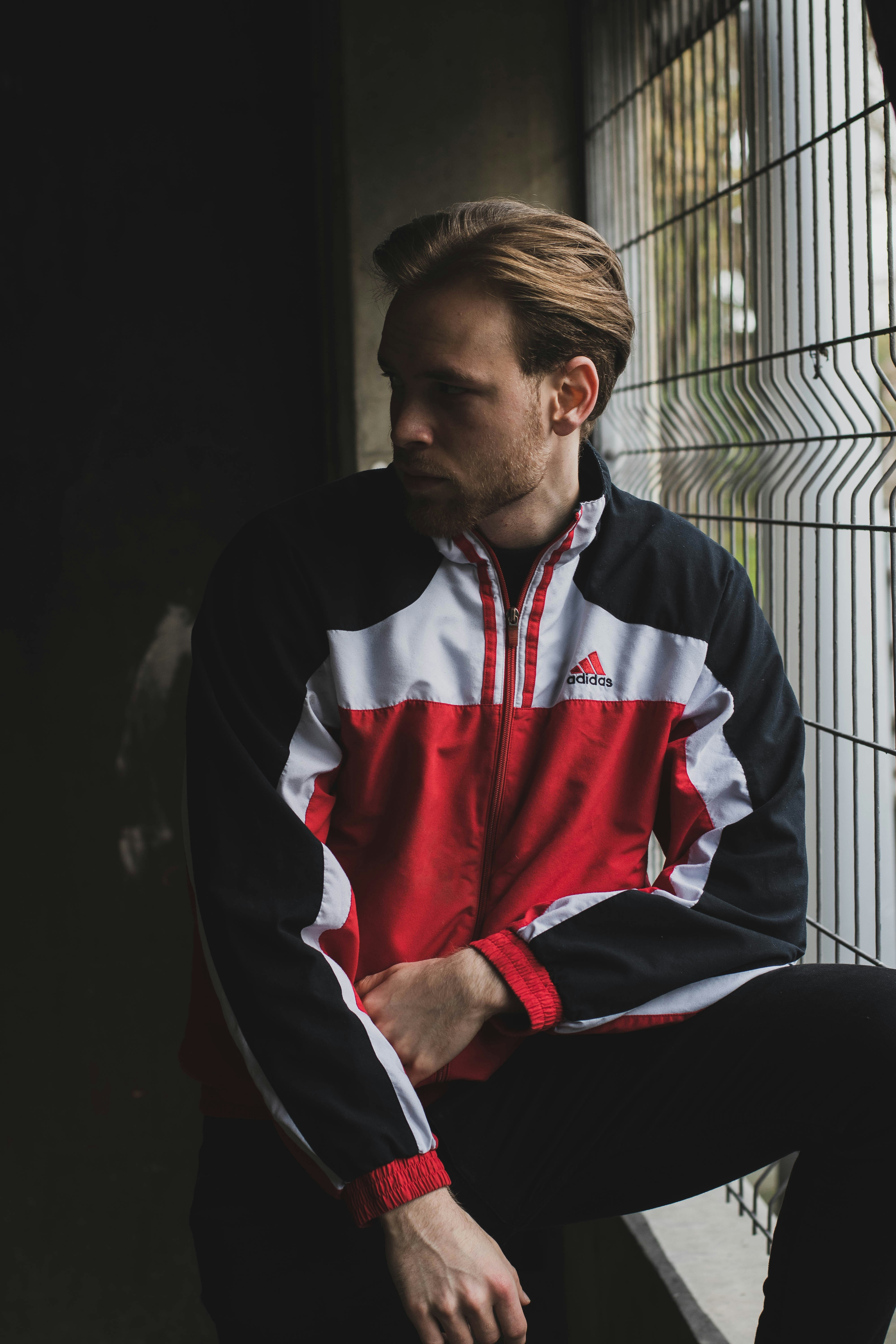 man in black white and red zip up jacket