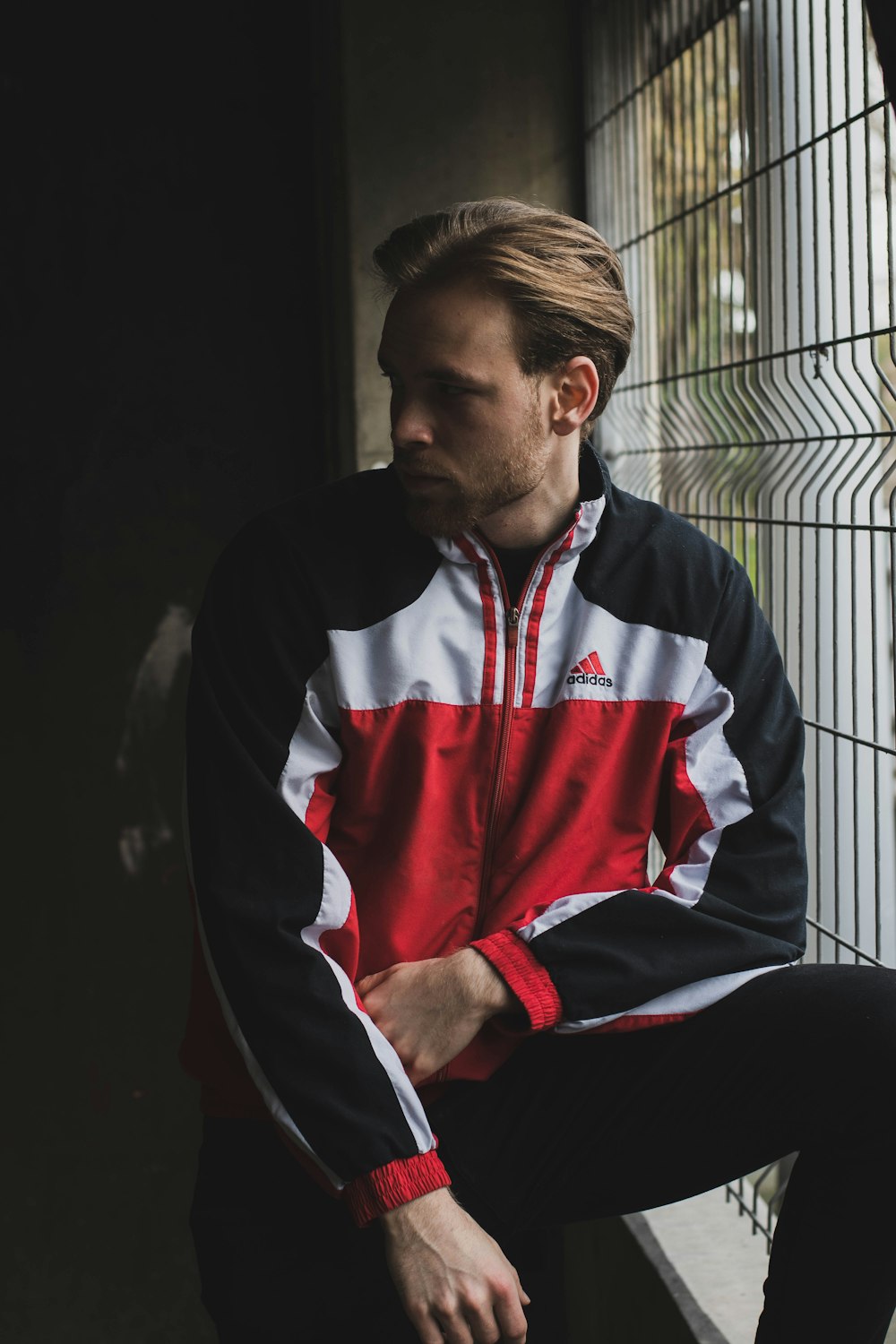 man in black white and red zip up jacket