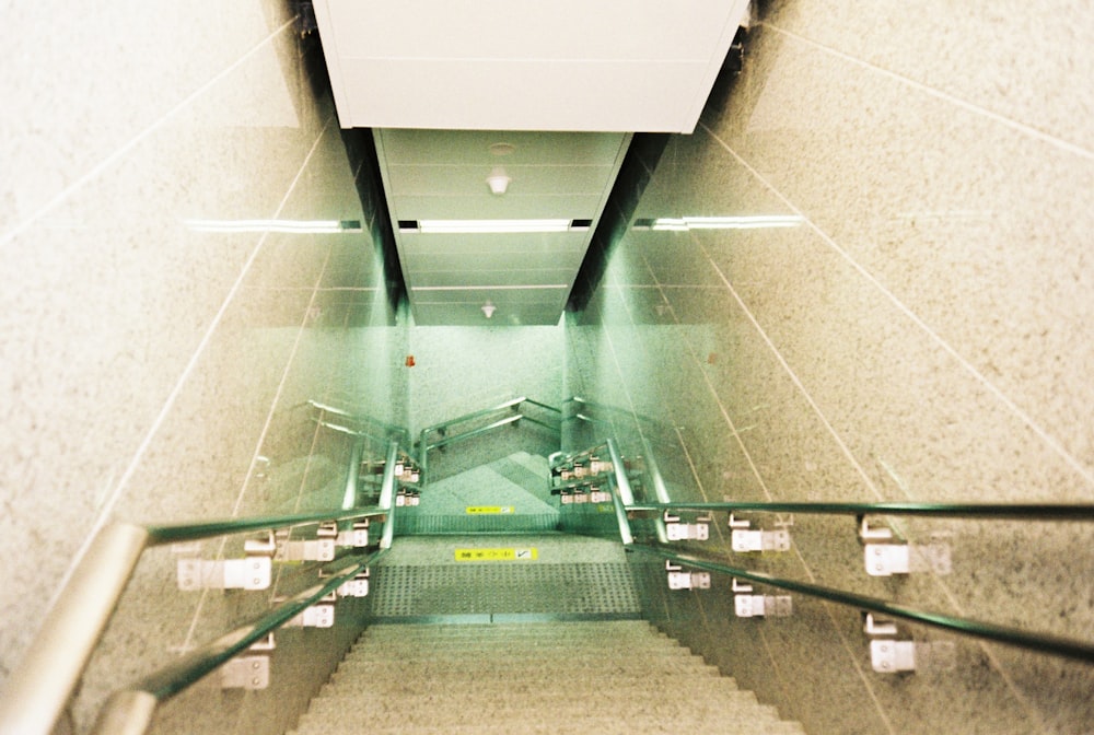 white and green staircase on white tiled floor