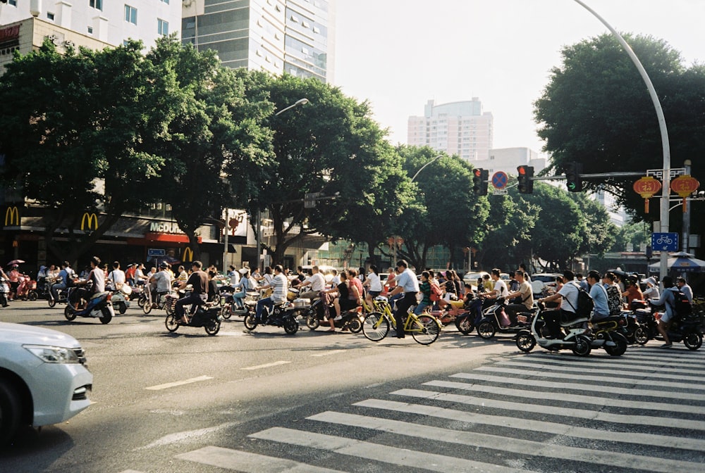 people riding bicycles on road during daytime