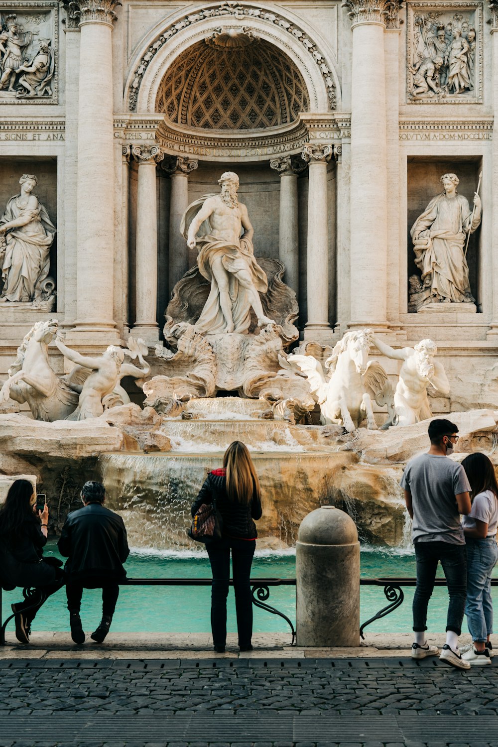 people walking around fountain during daytime