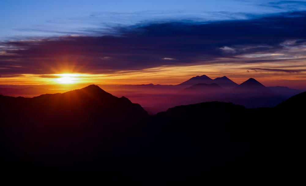 silhouette of mountains during sunset