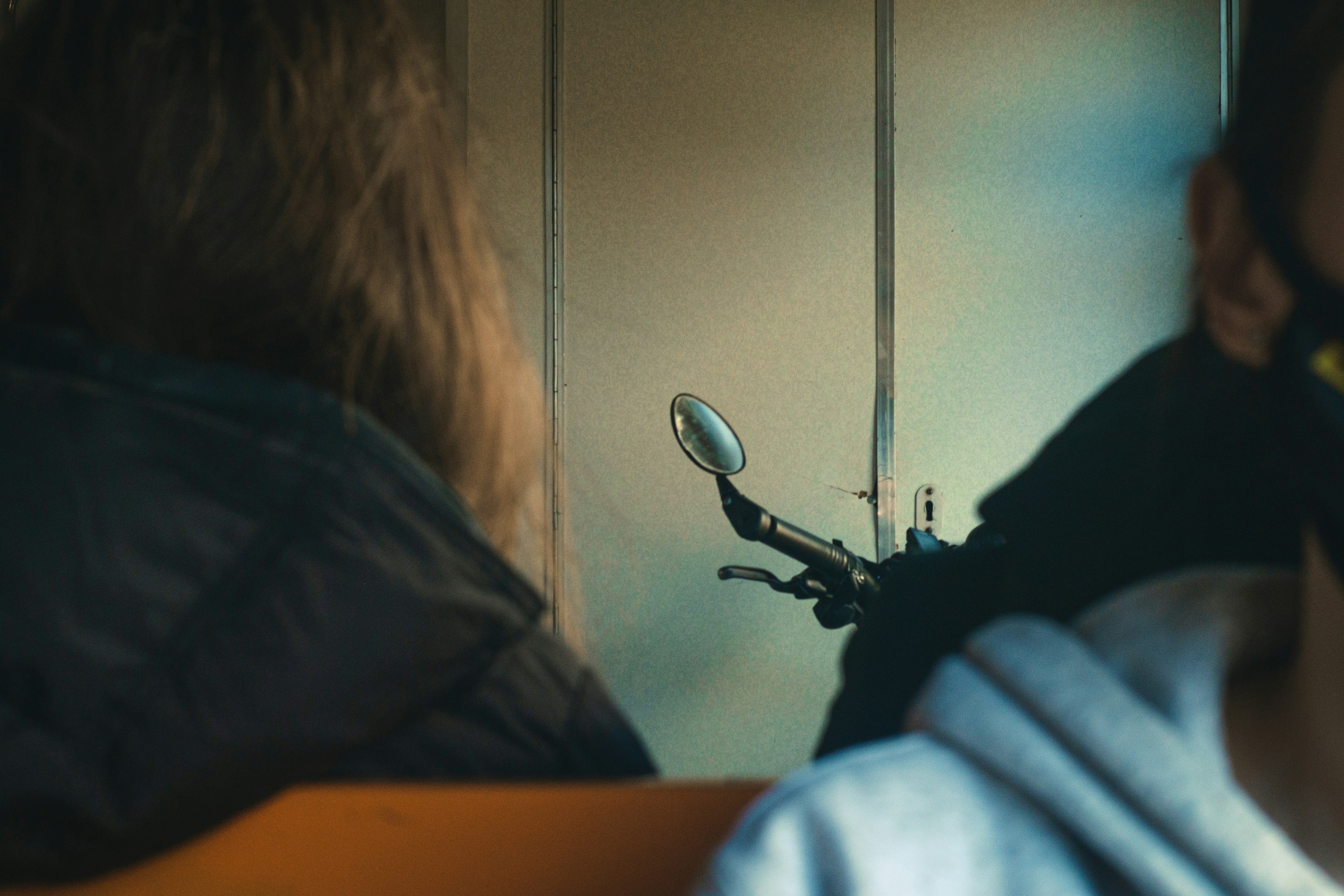 person in gray shirt sitting on chair