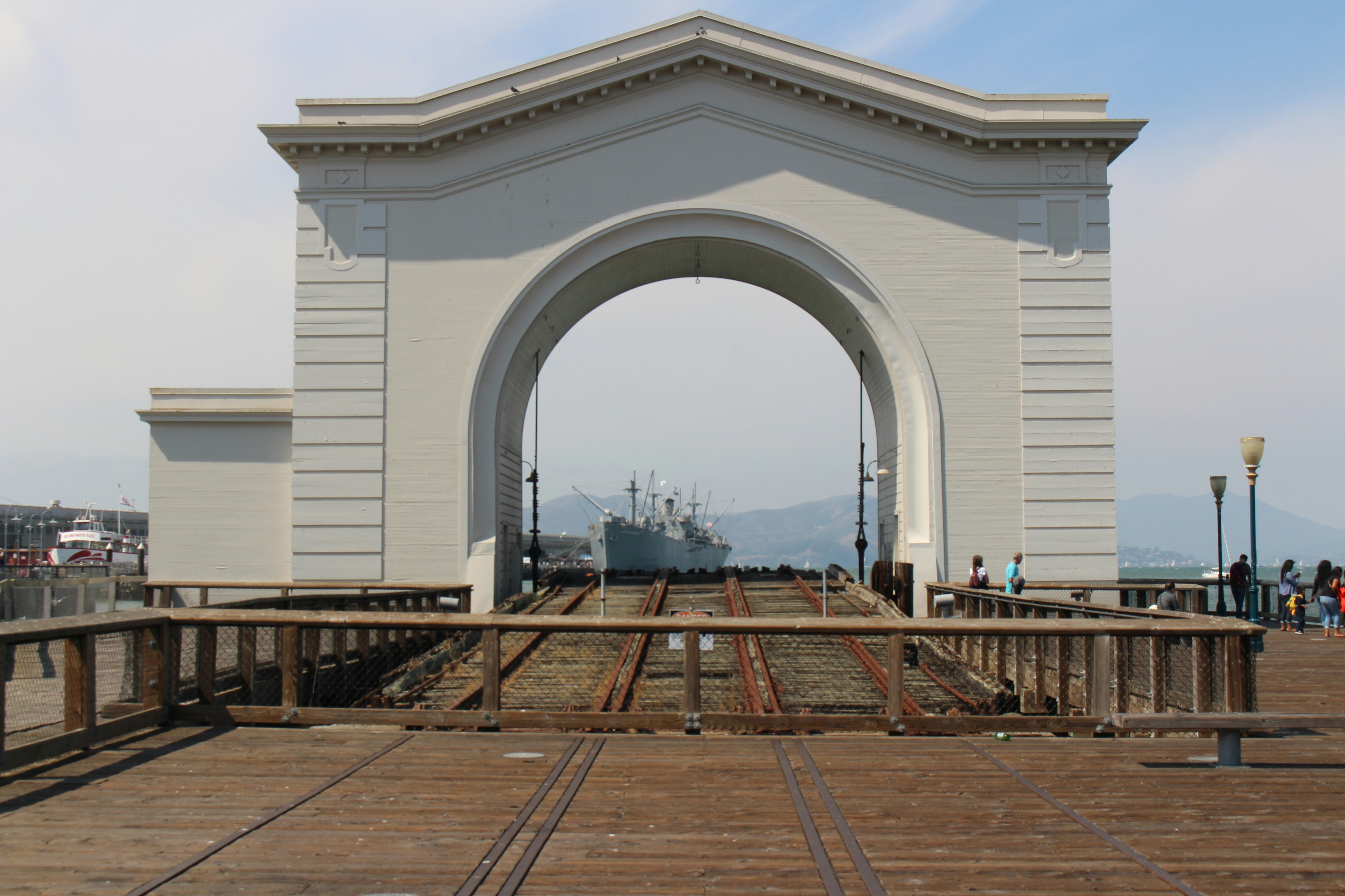 white concrete building with brown wooden bench