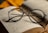 black framed eyeglasses on book page
