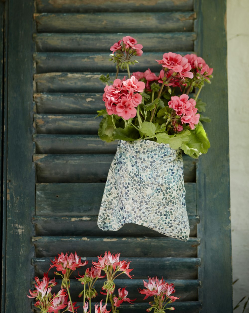 red flowers on white and blue floral textile