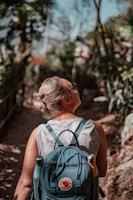 woman in teal tank top wearing black sunglasses