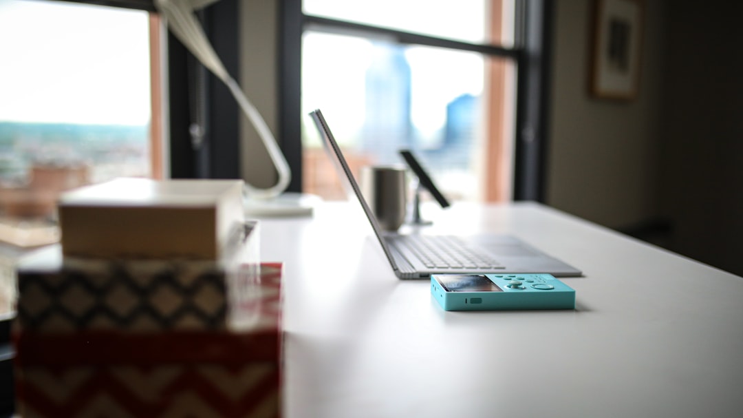 white and blue power bank on white table