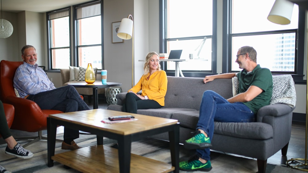 woman in yellow long sleeve shirt sitting on gray couch