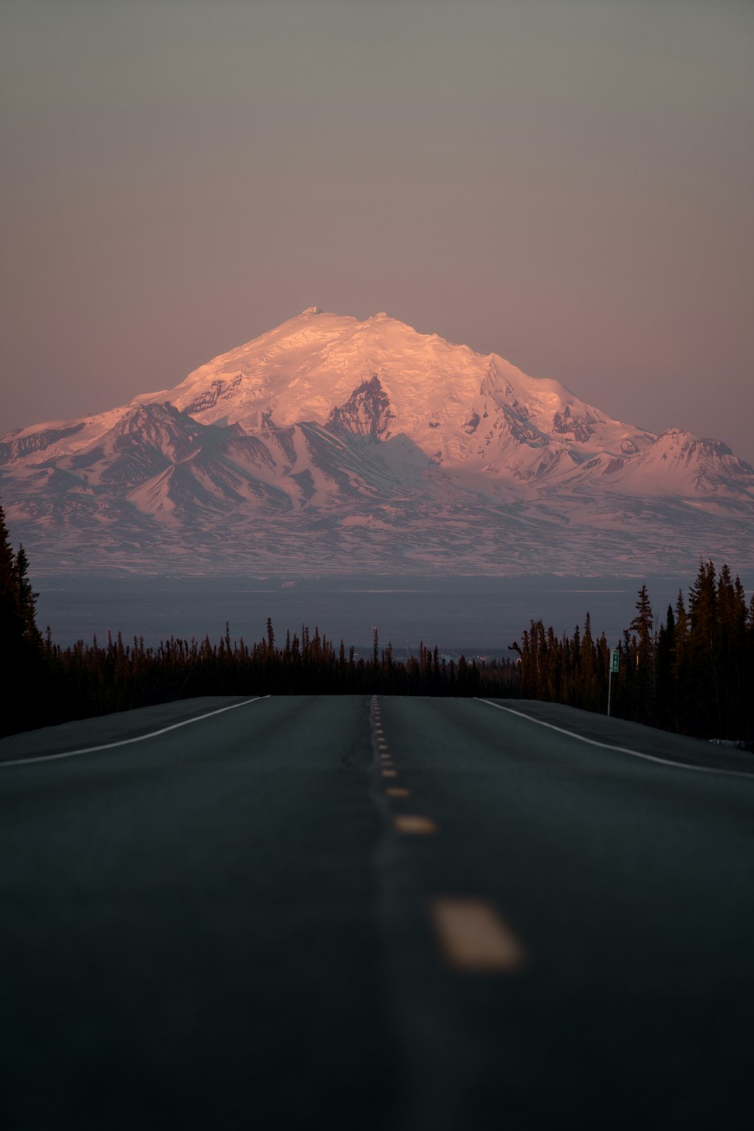 black asphalt road near snow covered mountain during daytime