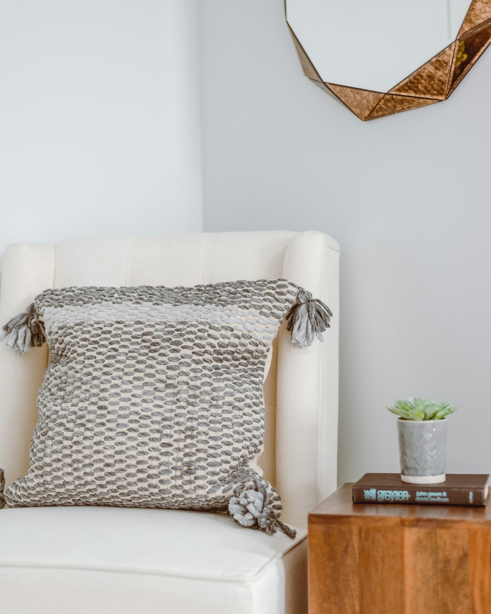 white and black throw pillow on brown wooden table