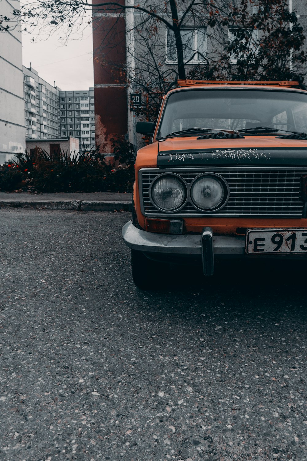 orange and black car parked on gray concrete road