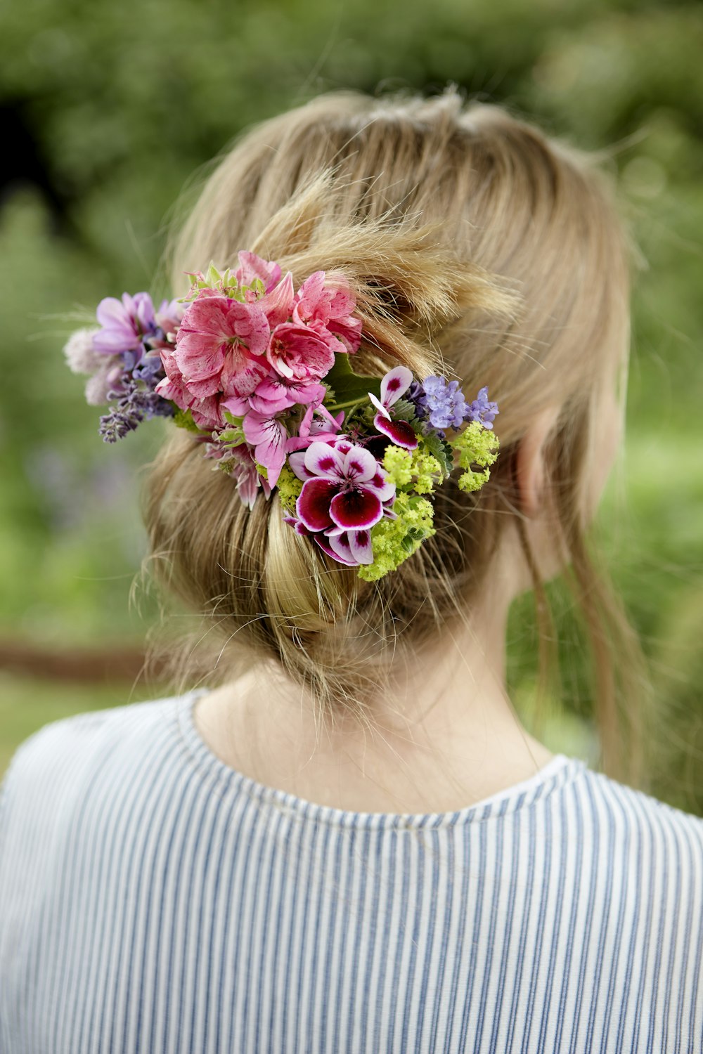 girl in white shirt with pink flower headband