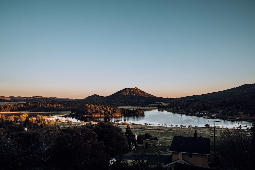 body of water near mountain during daytime