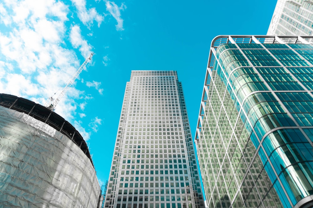 white and blue glass walled high rise building under blue sky during daytime