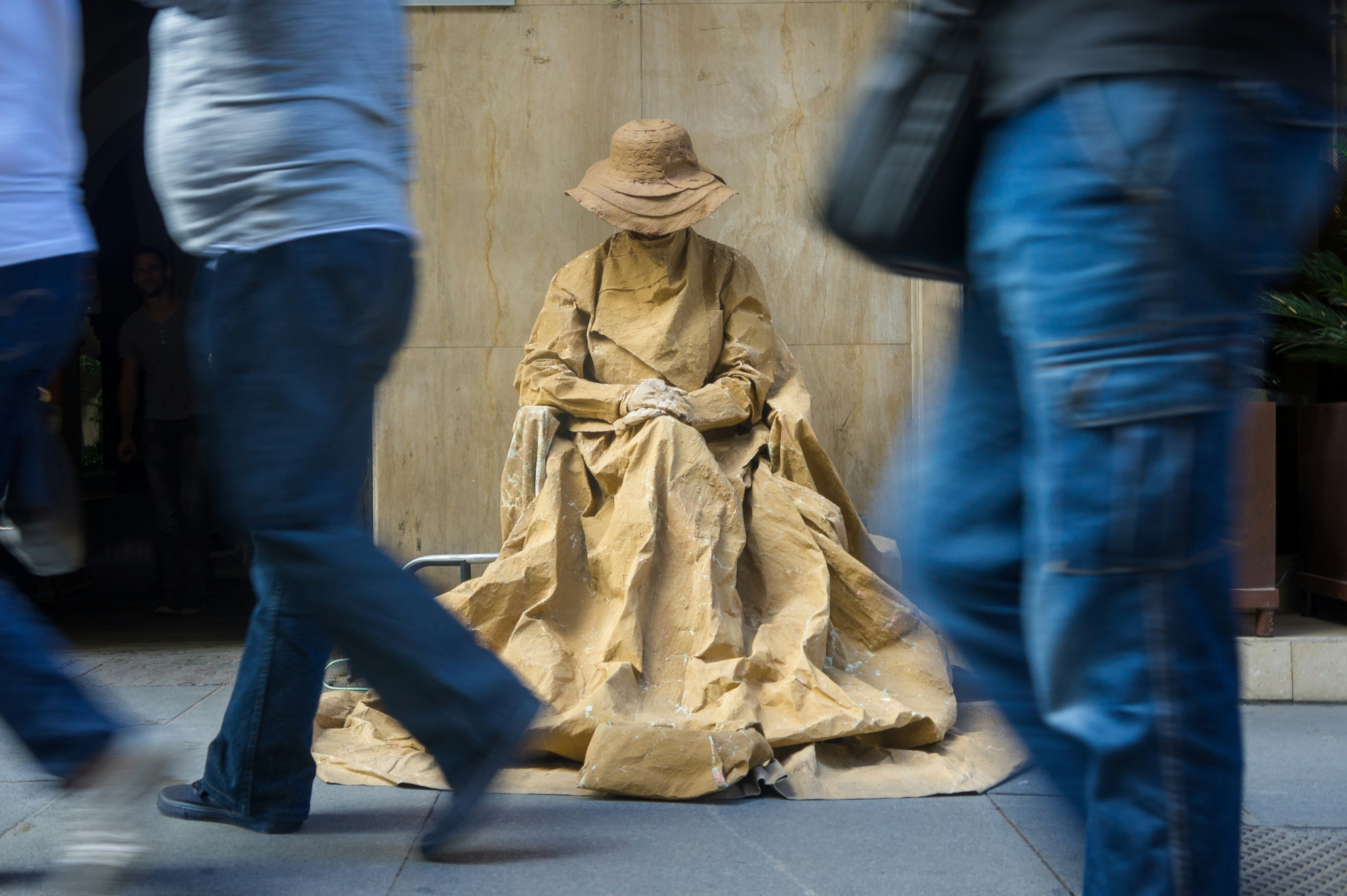 man in blue denim jeans and brown hat standing beside woman in beige dress