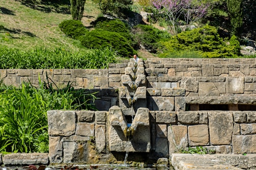 Naturalistic engineering with stone terraces blending into a hillside garden