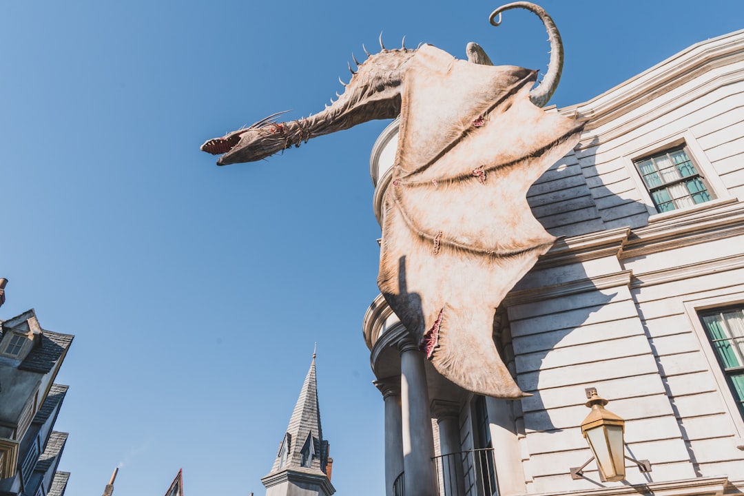 white dragon statue near white concrete building during daytime