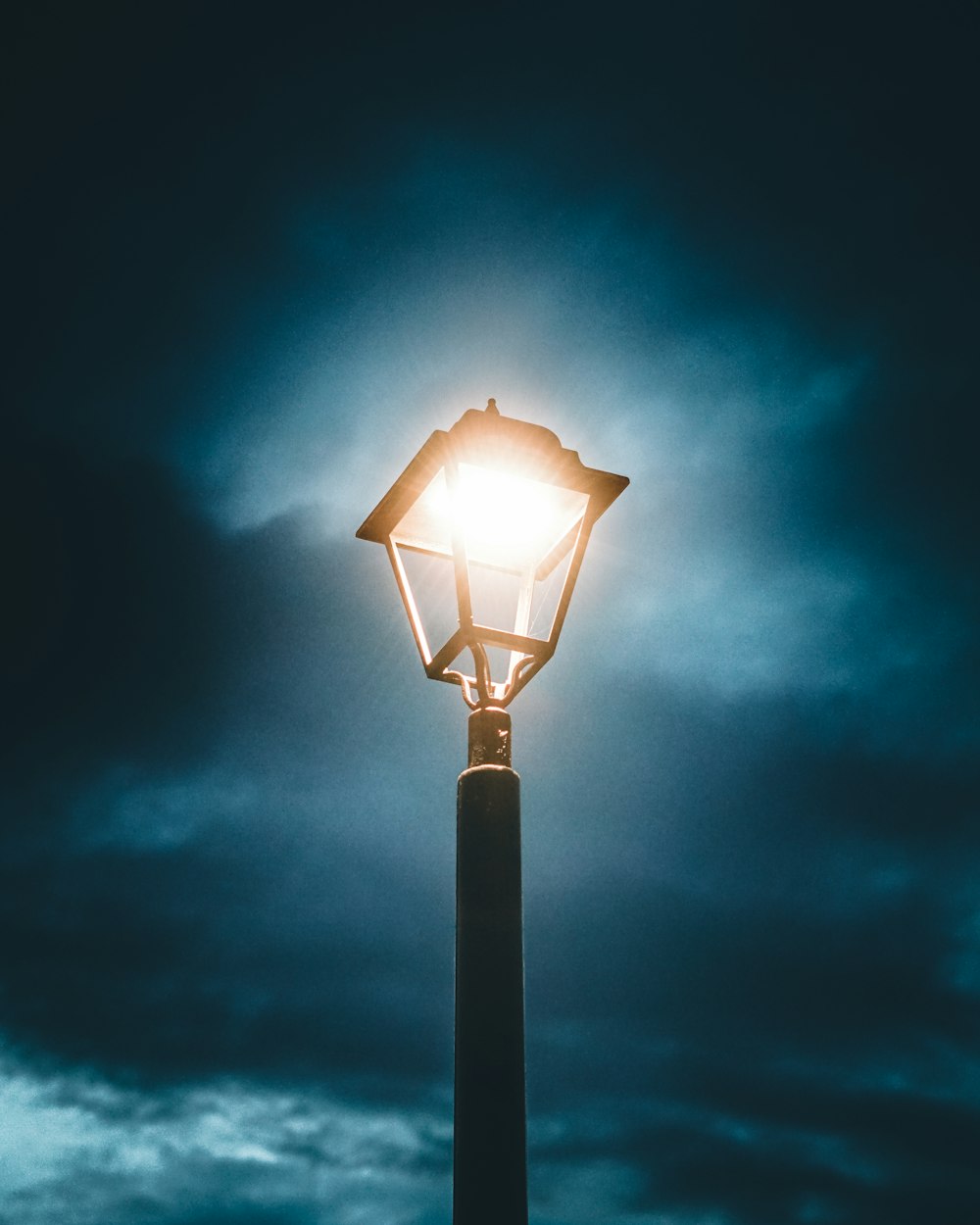 black street light under blue sky