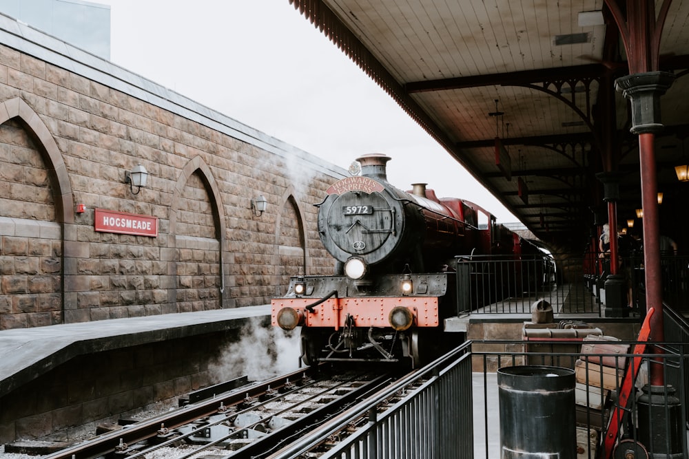 red and black train on rail tracks during daytime